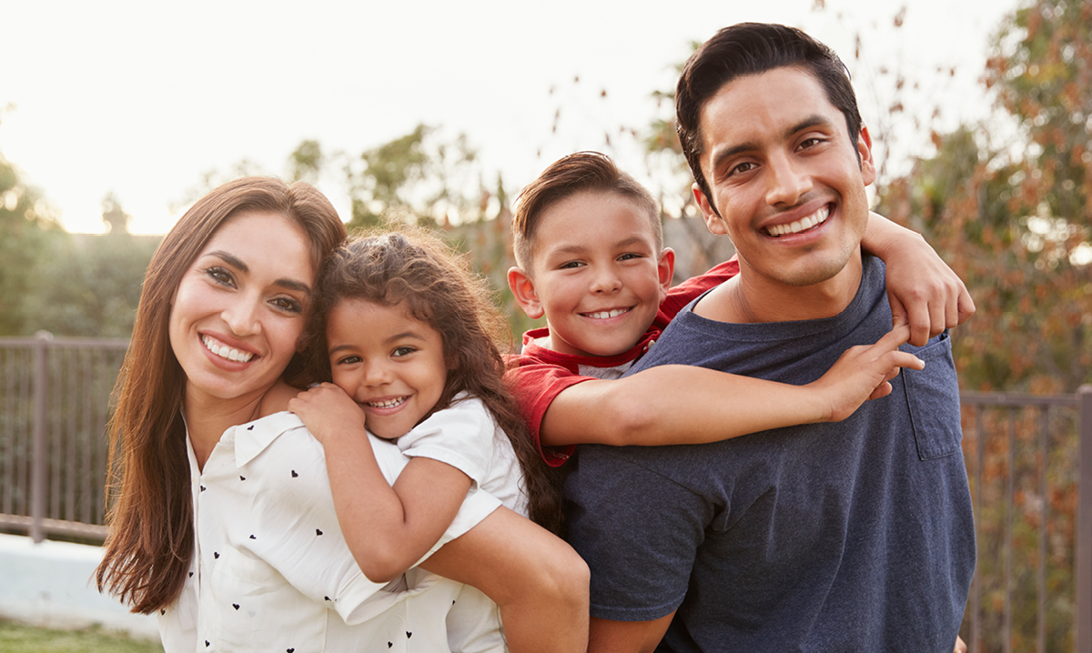 Family of four smiling