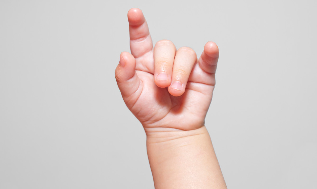 baby holding up music horns