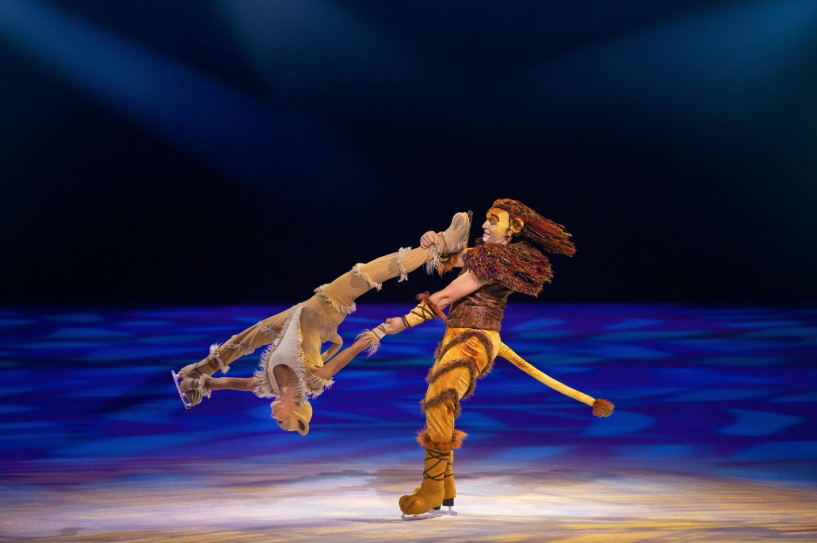 Two ice skaters dressed as lions