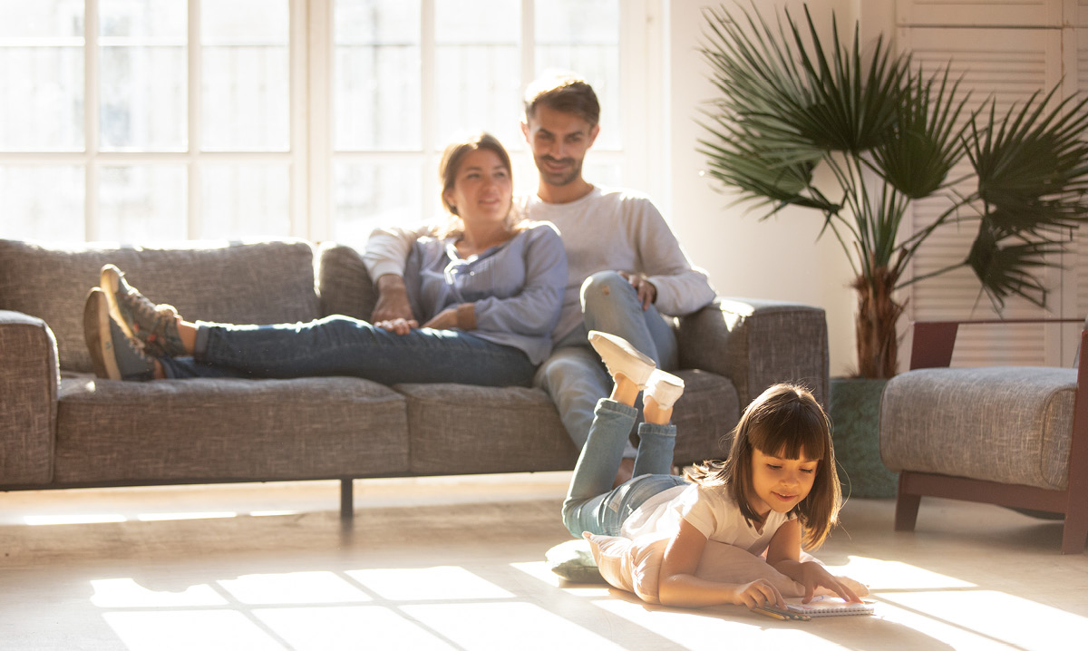 Family of three in a living room