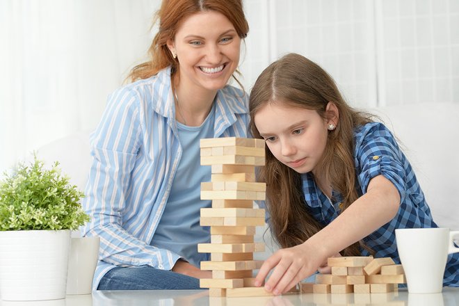 Woman and girl playing Jenga