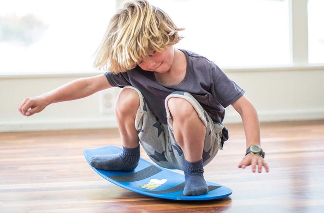 Kid playing on a toy indoors