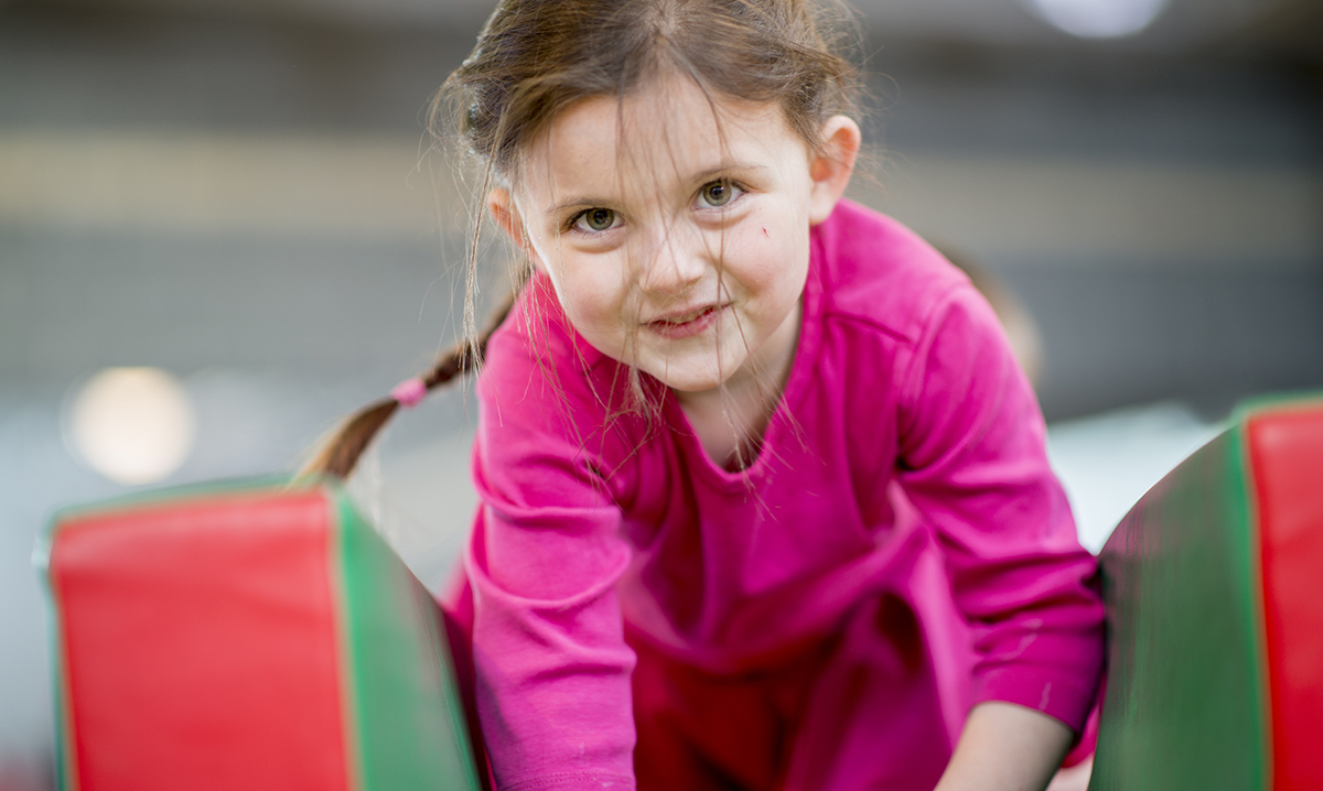 Child playing on an indoor obstacle course