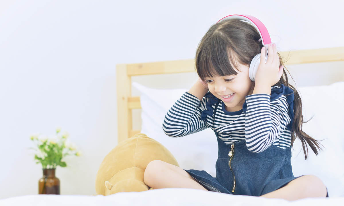 Girl smiling while listening to headphones