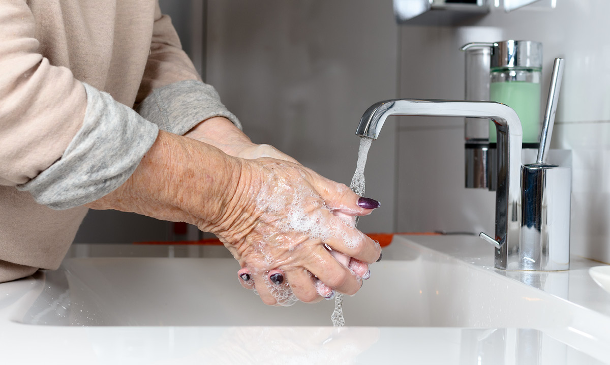 Elderly person washing their hands