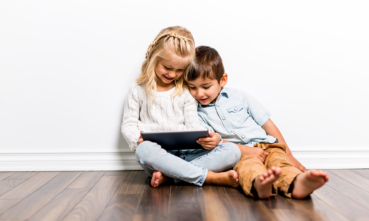 Two kids playing on tablet