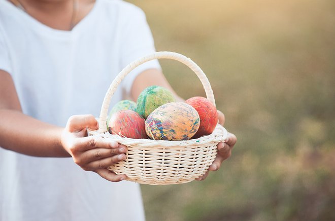 Woman holding a basket of Easter eggs