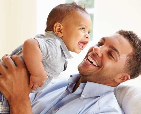 Virtual Baby Size Story Time with Royal Oak Public Library Man holding a baby