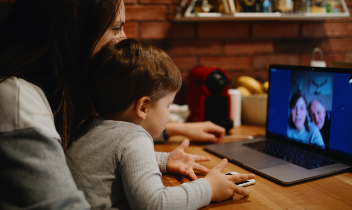 Woman and child FaceTiming an elderly couple