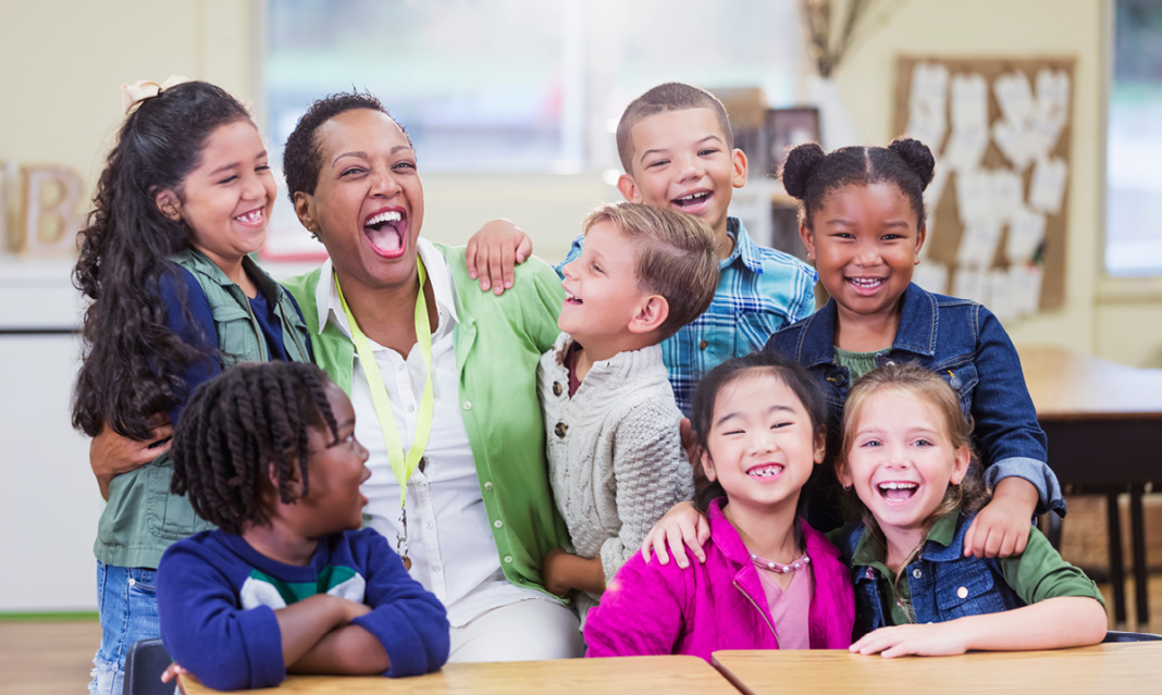 Kids hugging their teacher