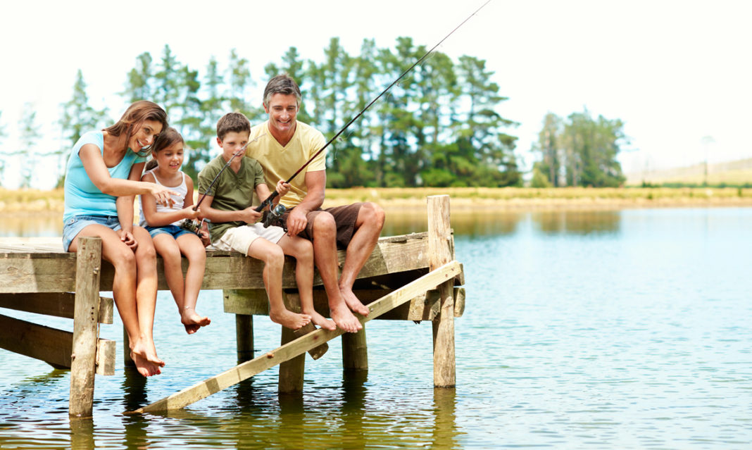 A family fishing on a dock