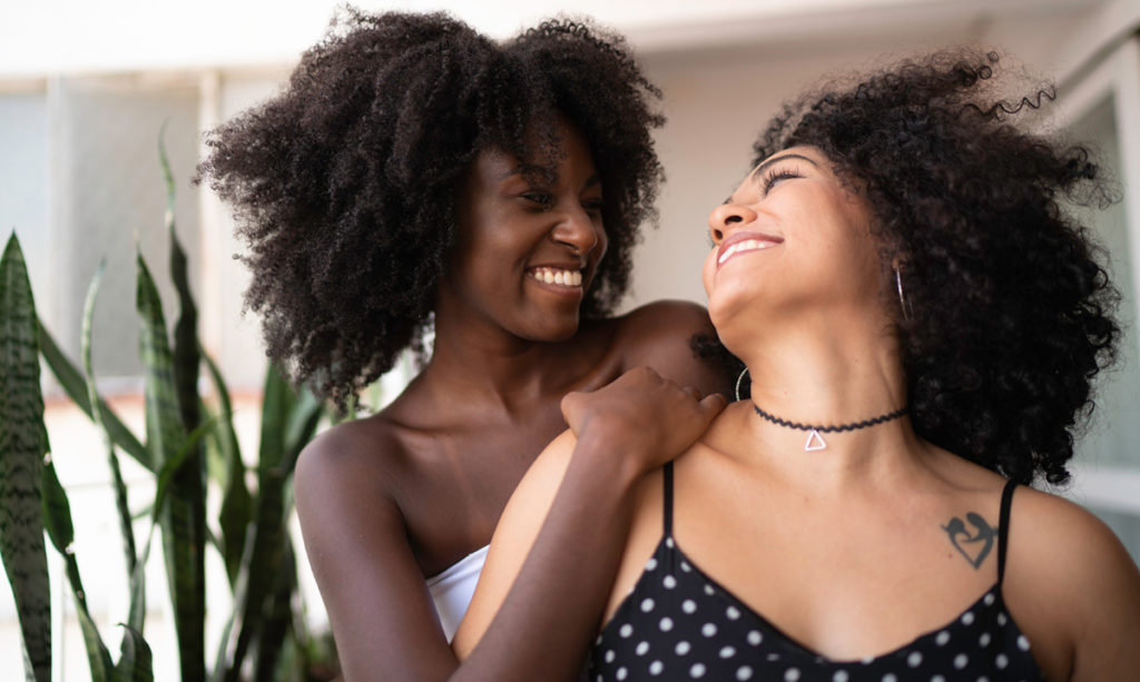 Two-black-women-smiling-at-each-other