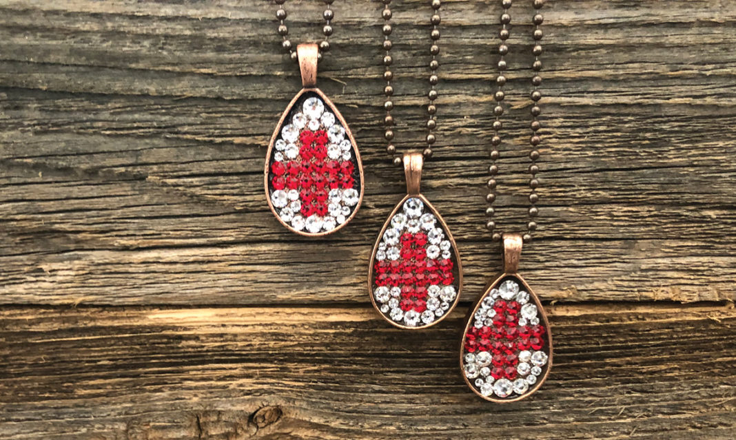 Pretty Hunter healthcare heroes necklaces on a wood background