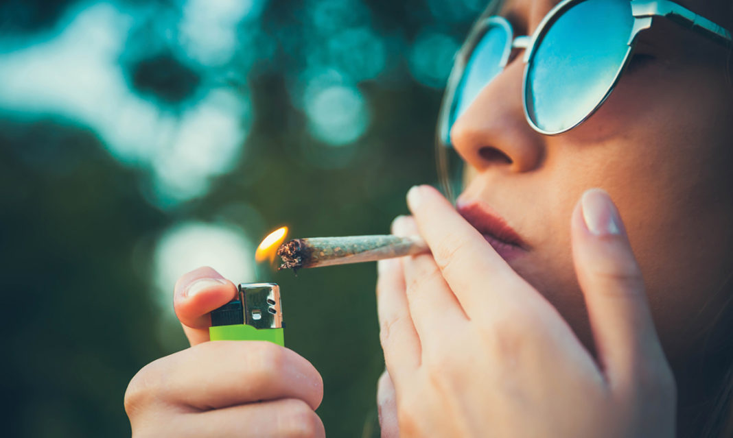 Woman lighting up a joint
