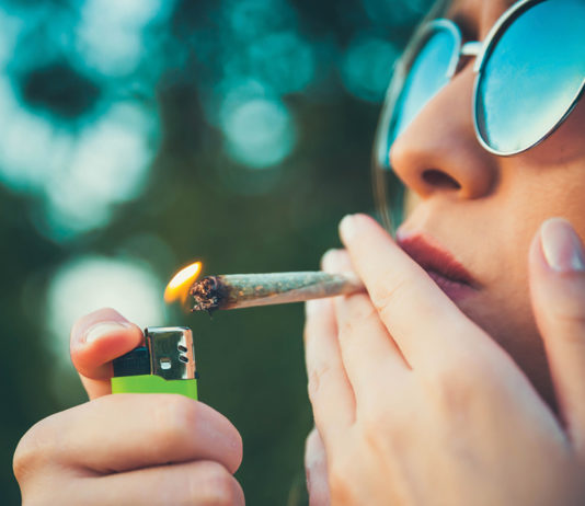 Woman lighting up a joint