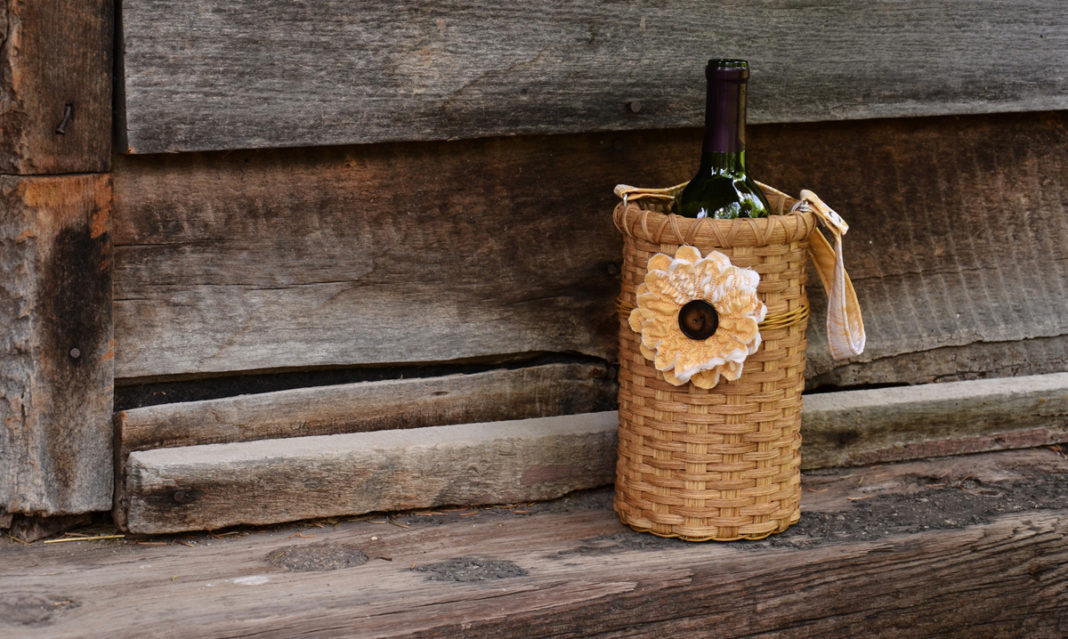 A bottle of wine in a pretty basket