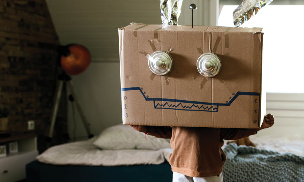 Kid with a decorated cardboard box on their head