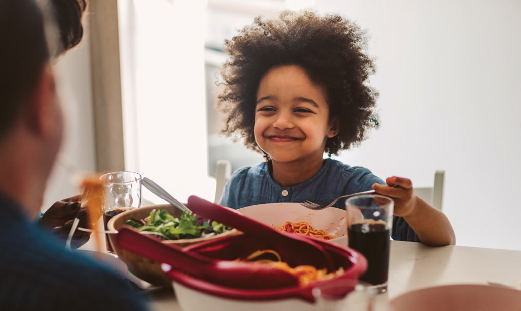 child-smiling-while-eating-istock