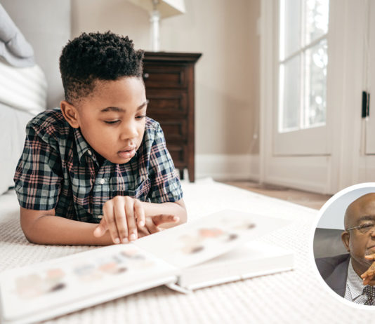 A child enjoying a book outdoors during summer reading time