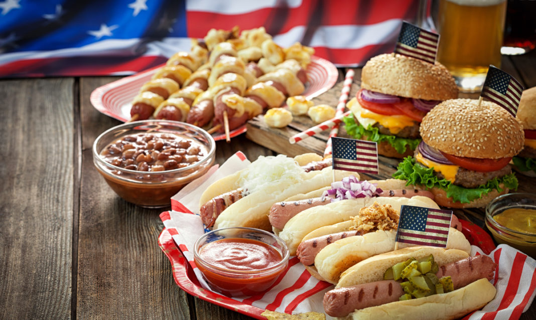 Hamburgers and hotdogs on a picnic table
