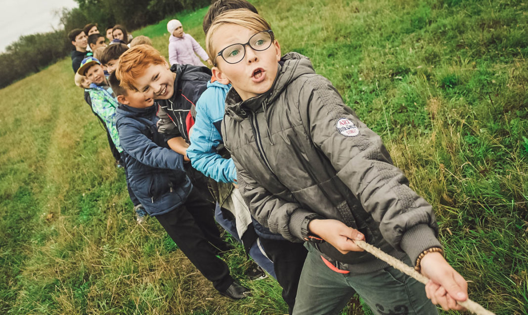 Kids playing tug-of-war at camp