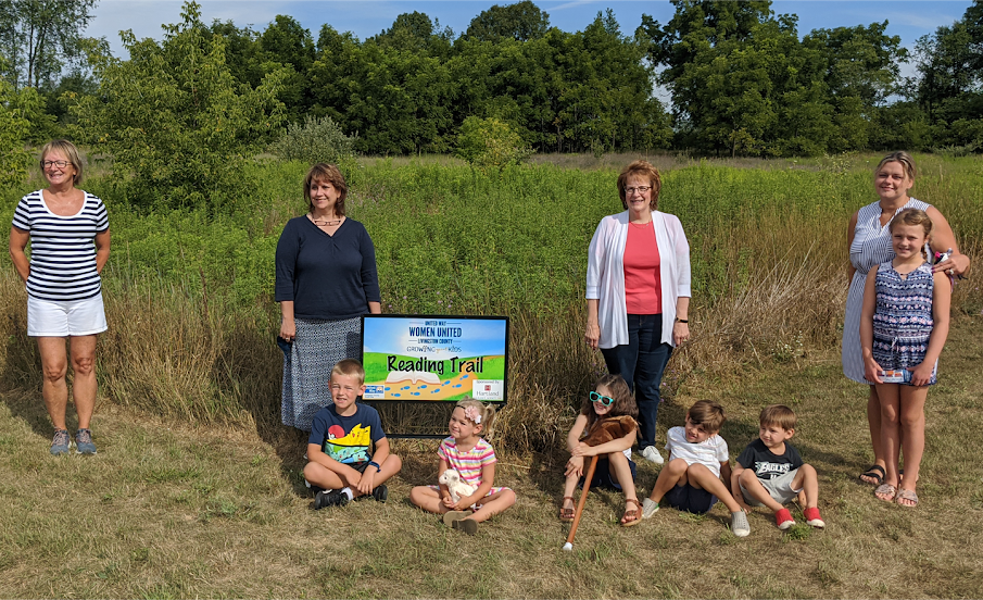 Woman standing on the Livingston County reading trail