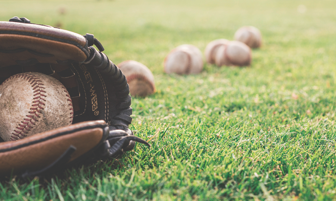 Close-up of a baseball mitt and some balls