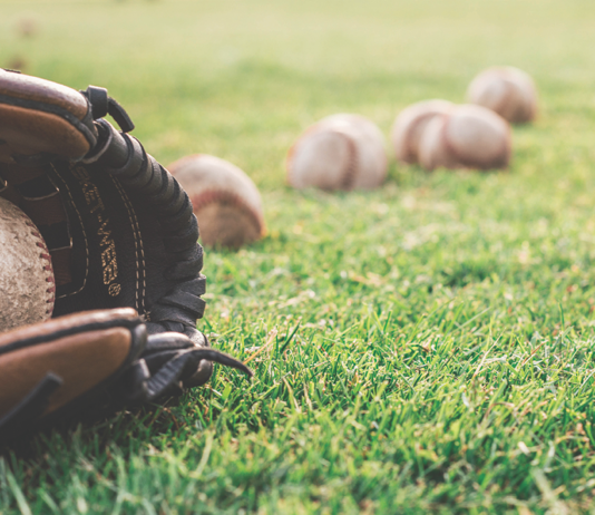 Close-up of a baseball mitt and some balls
