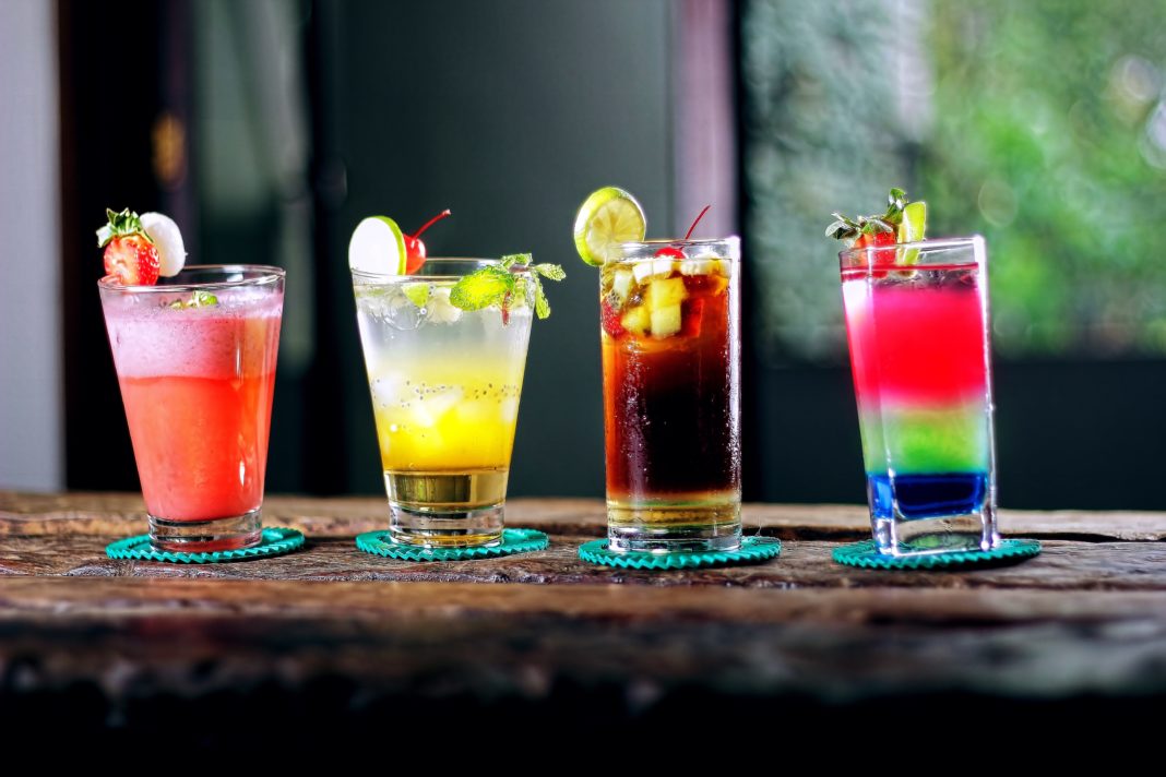Four drinks lined up on a counter