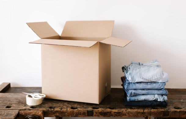 Pants and tape next to a move-in box