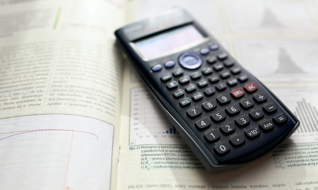 A calculator sitting on a book