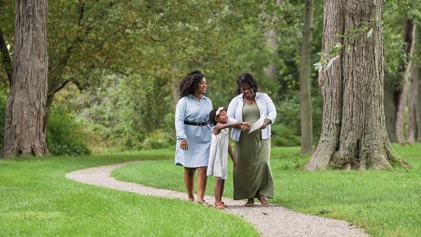 Family walking the grounds of the Edsel and Eleanor Ford House