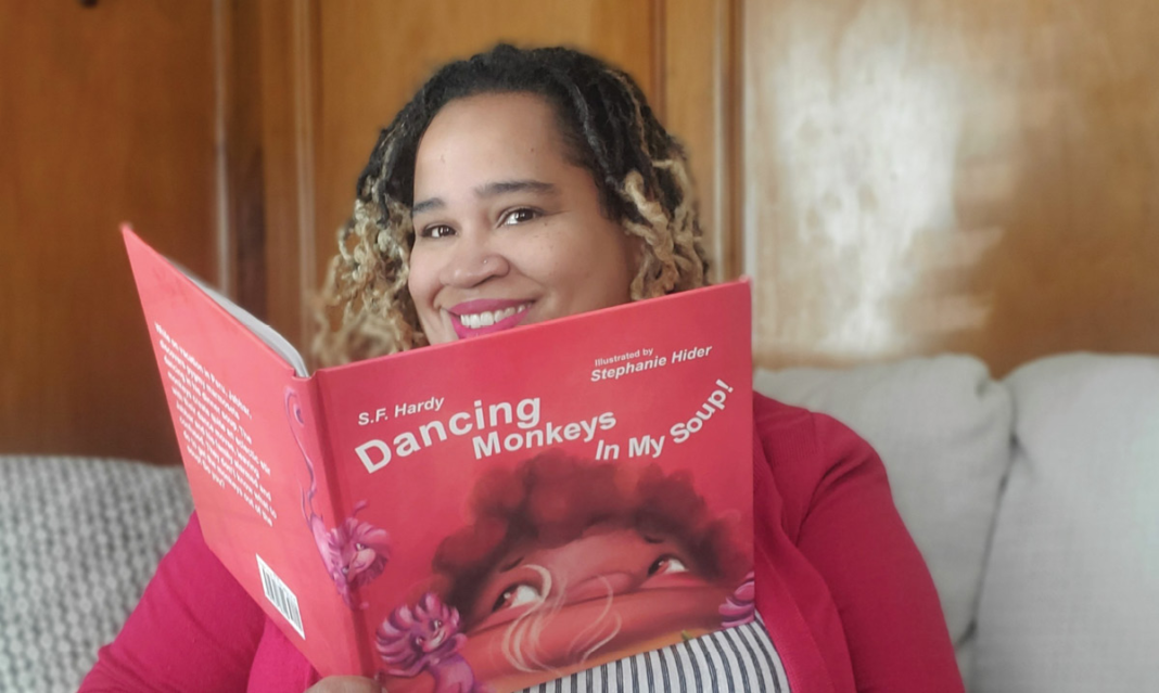 Detroit author with her book
