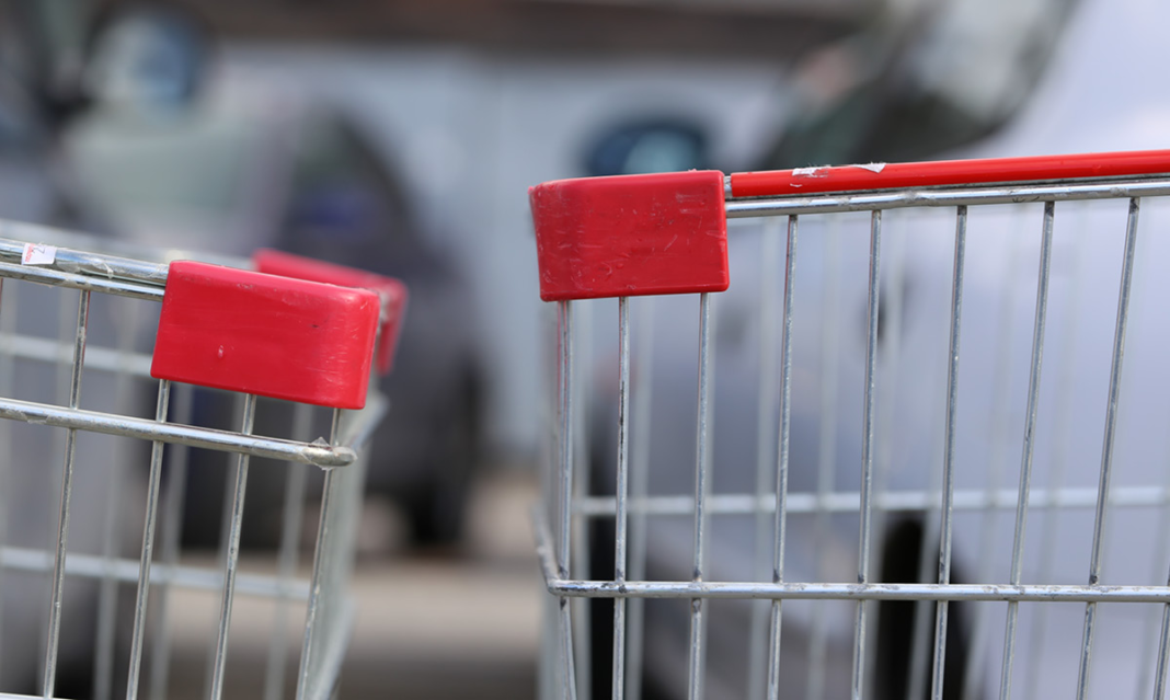 The end of two shopping carts running into one another