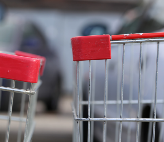 The end of two shopping carts running into one another
