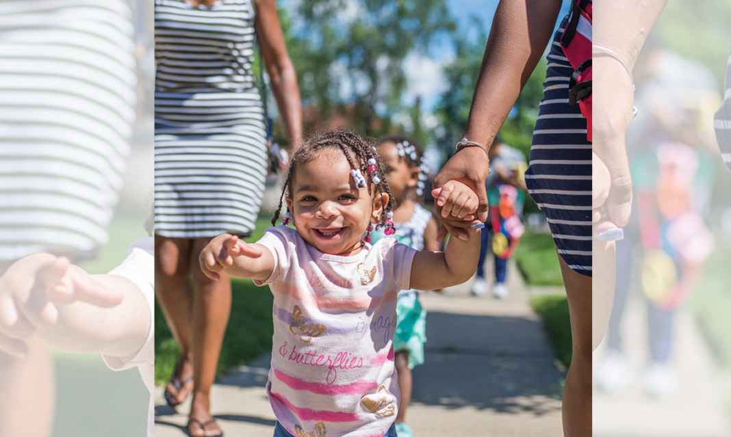 Smiling little girl pointing at the camera