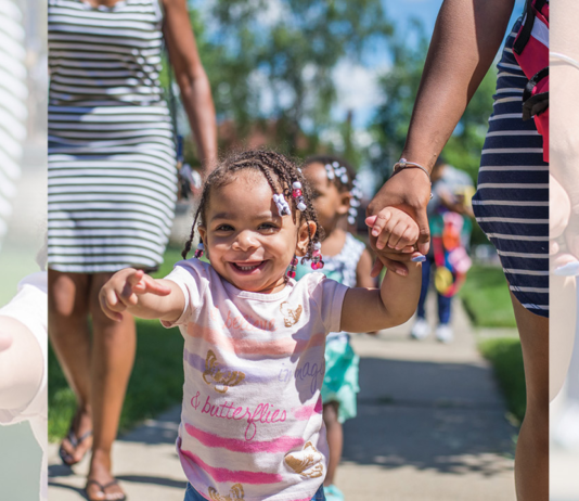 Smiling little girl pointing at the camera