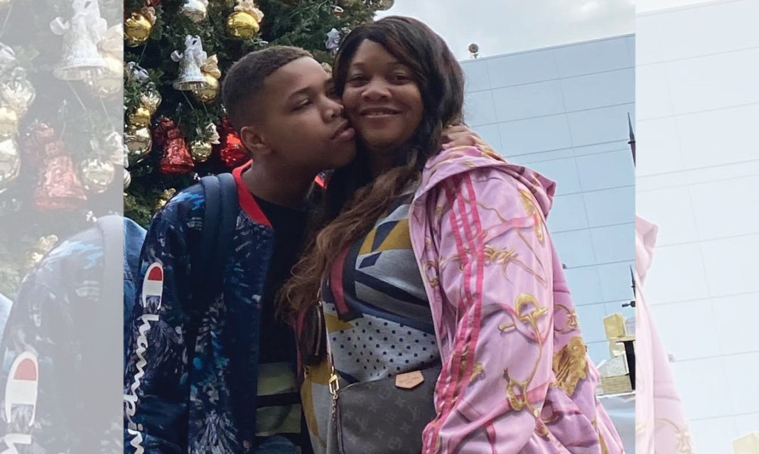Camille Proctor getting a kiss on the cheek from her son