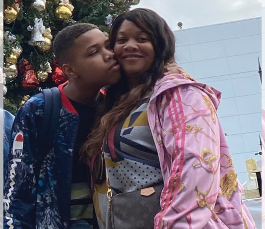 Camille Proctor getting a kiss on the cheek from her son