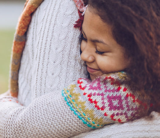 Learning How to Forgive Others Close-up of a tween hugging someone in a white shirt
