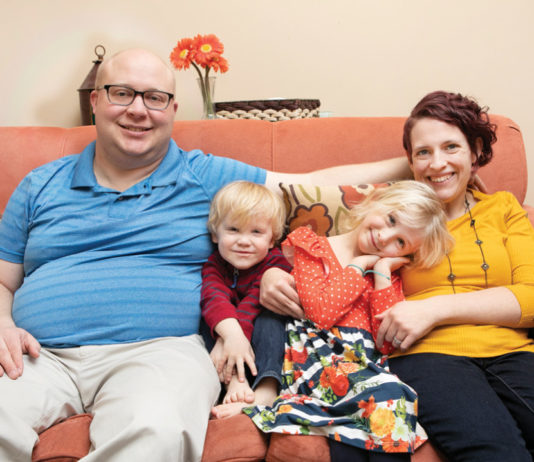 Parenting with Cerebral Palsy Christine Dubois and family sitting on her couch