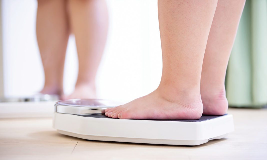 Close-up of feet standing on a scale