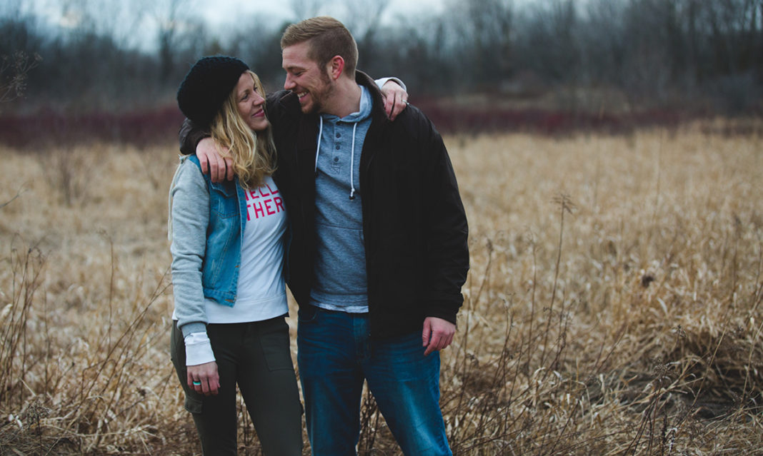 Woman and man hugging in a field