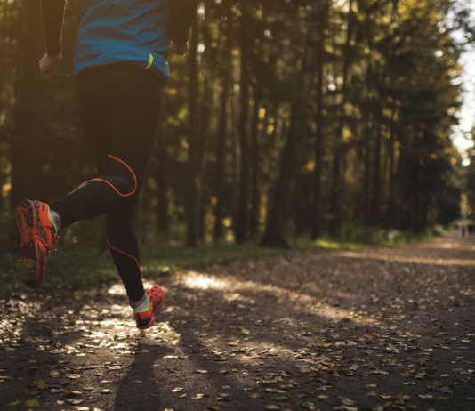 Close-up of a person running on a wooded trail