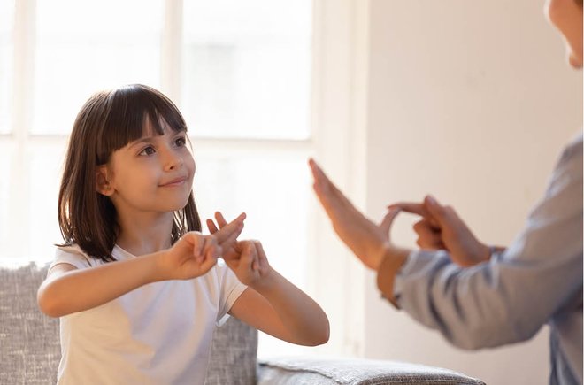 Young girl learning sign language