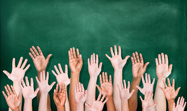 Different color hands being raised