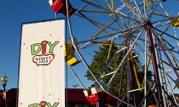 Sign for the DIY fair in front of a ferris wheel
