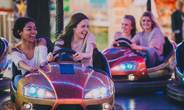 Teens riding in bumper cars