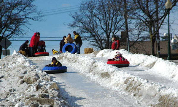 Kids tubing down a hill