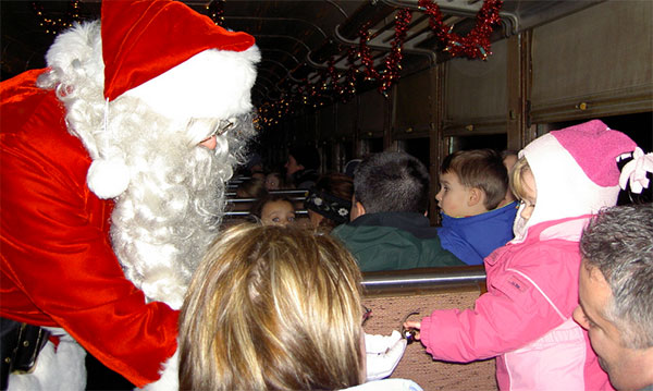 Santa passes out goodies on the holiday express train ride